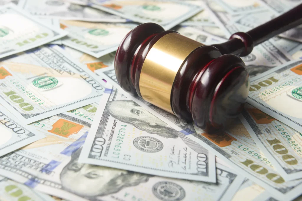 A gavel on a pile of cash.