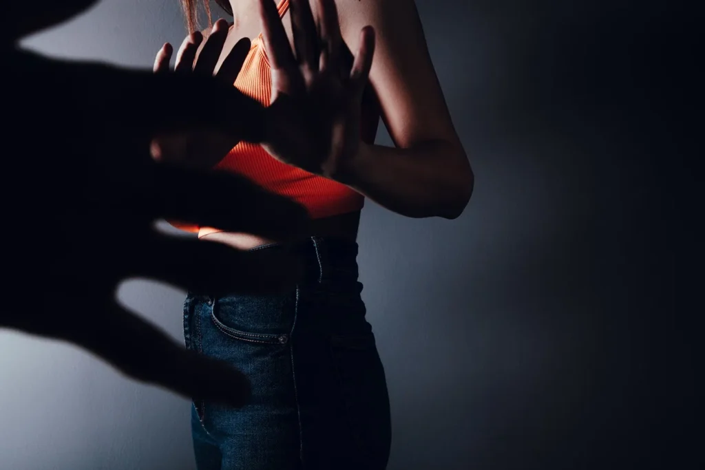 A man overpowering a woman.