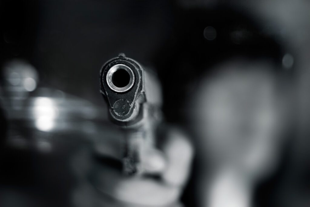 A gun pointing at the camera.