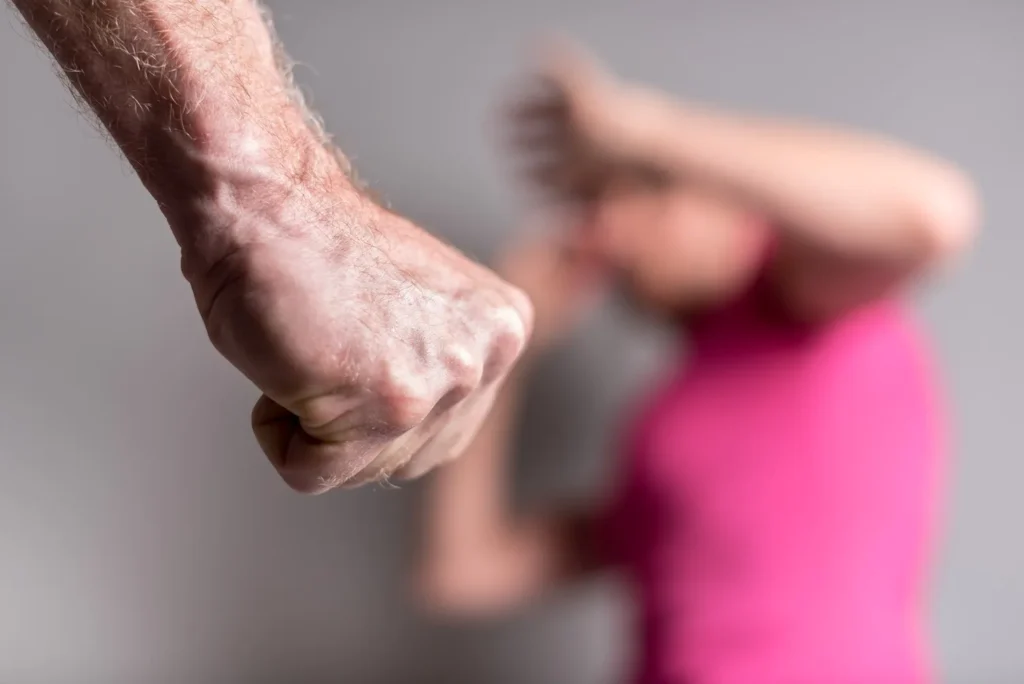A man balling up his fist in front of woman.