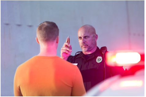 A man being given a field sobriety test.