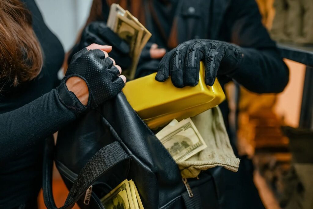 Someone stashing money into a bag.