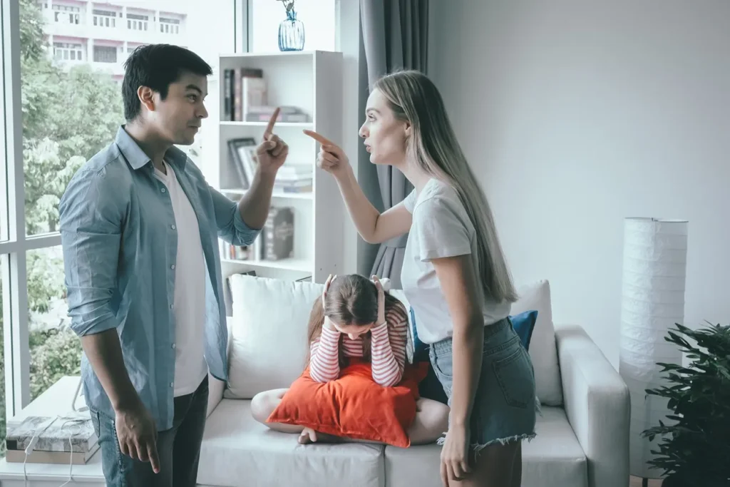 Parents arguing in front of their child.