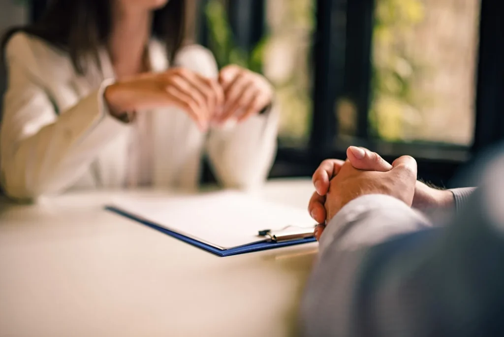 Close-up of a client meeting with a DWI lawyer in a professional office setting, symbolizing the importance of contacting a Dallas DWI lawyer promptly.