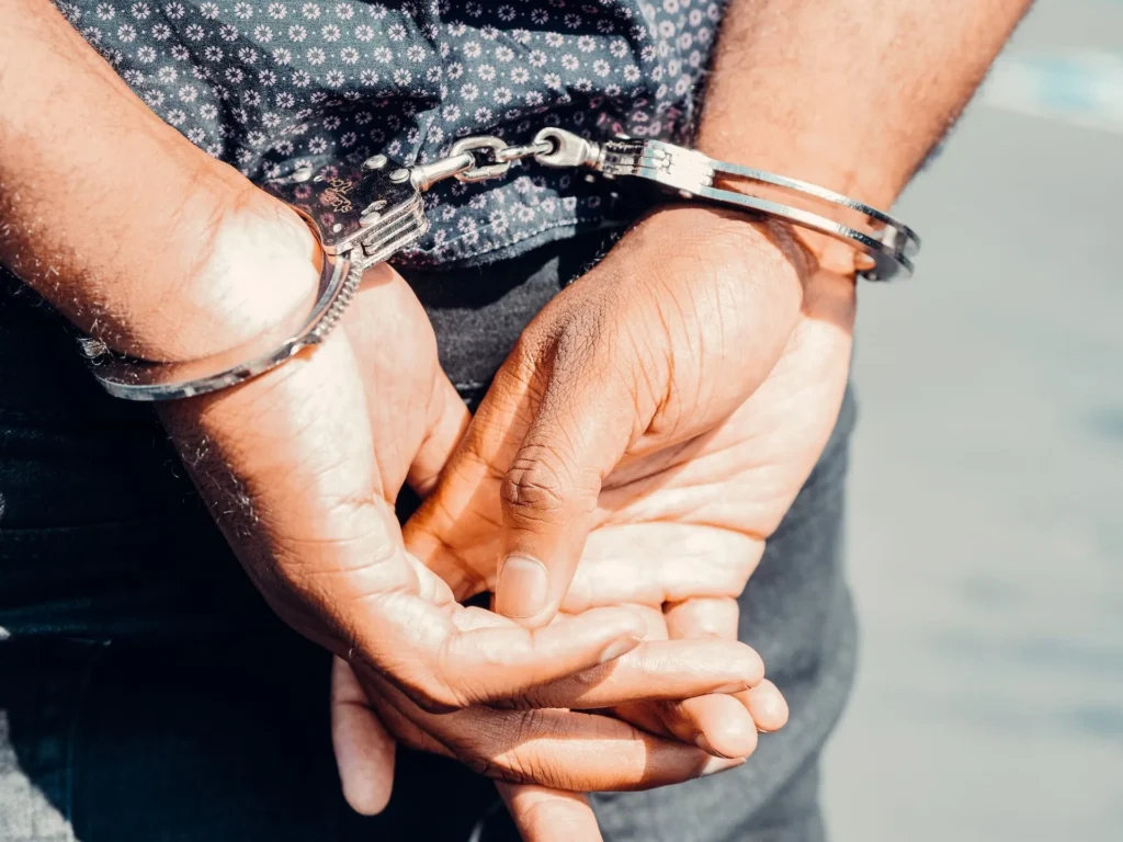 Close-up of a person in handcuffs with hands behind their back, representing the consequences of a probation violation in Collin County.