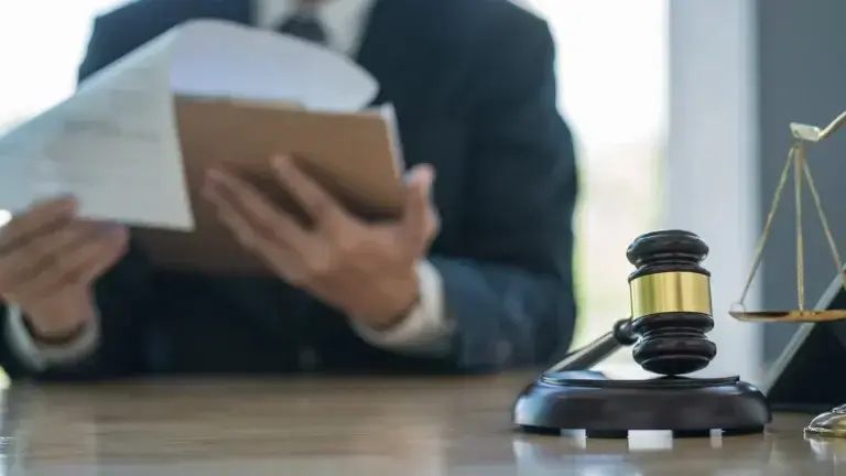 lawyer at desk with paperwork and gavel